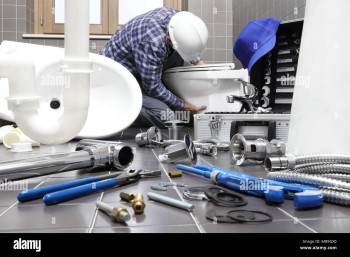 plumber-at-work-in-a-bathroom-plumbing-repair-service-assemble-and-install-concept-MB9GX0